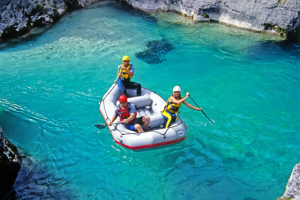 Three people rafting together at Soca b