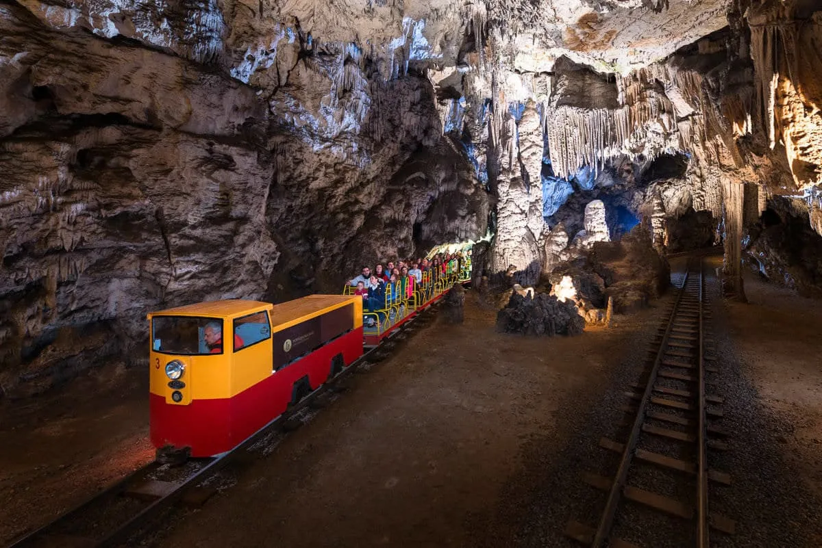 postojna cave train with visitors e a